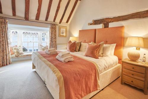 a bedroom with a large bed and a window at The Angel Inn, Petworth in Petworth