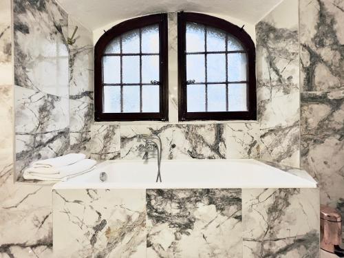 a bathroom with a sink and a window at Montreux Castle | Charming Lake View Studio in Montreux