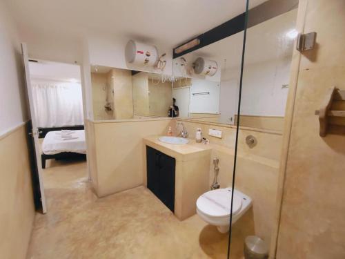 a bathroom with a toilet and a sink and a shower at VILLA M - SOLITUDE 2 CANDOLIM GOA 3BHK, Pool Facing, Near Beach, Free Breakfast, Free WIFI and Prime Location in Candolim