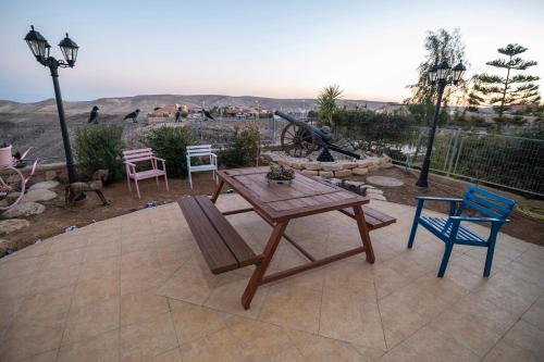 a wooden table and chairs sitting on a patio at House of Art in Arad