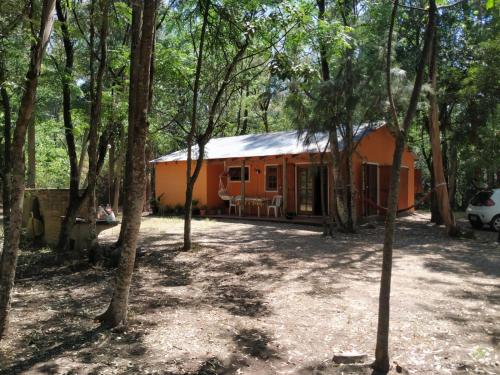 an orange house in the middle of a forest at Mis Soles in Santa Ana