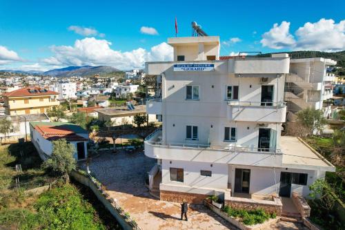 a building with a man standing on top of it at Guest House Gerard in Ksamil