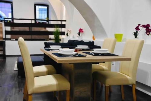 a dining room with a wooden table and chairs at Nuovo Casa in Sopron