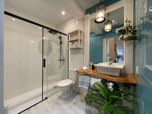 a bathroom with a shower and a toilet and a sink at Apartamentos LÓRIEN Zarautz in Zarautz