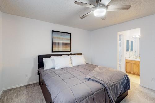 a bedroom with a bed with a ceiling fan at Springs Manor in Colorado Springs