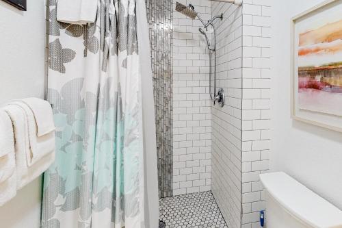 a bathroom with a shower with a shower curtain at Springs Manor in Colorado Springs
