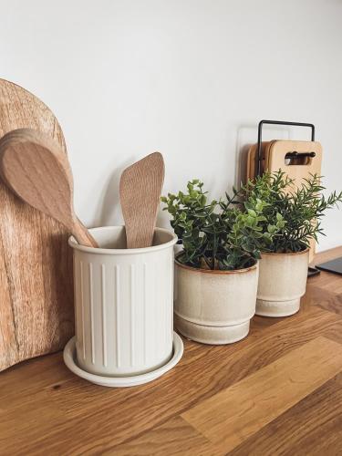 three potted plants sitting on a table with sidx sidx at Apartmány Zahražany in Most