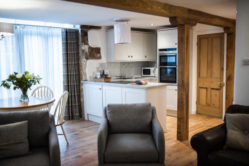 a kitchen and dining room with a table and chairs at Howgill House Barn in Draughton