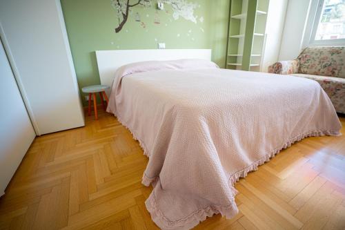 a bedroom with a bed with a pink blanket on it at MICKY HOUSE in Sanremo