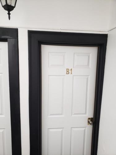 a white door with the letter b on it at The Jazz Suite B1 in Hartford