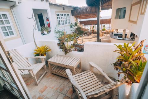 a patio with two chairs and a table at Agora Pousada e Bar in Pipa