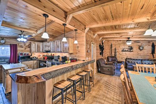 a kitchen and living room with a bar in a cabin at Otego Home with Hot Tub Near All Star Village! in Oneonta