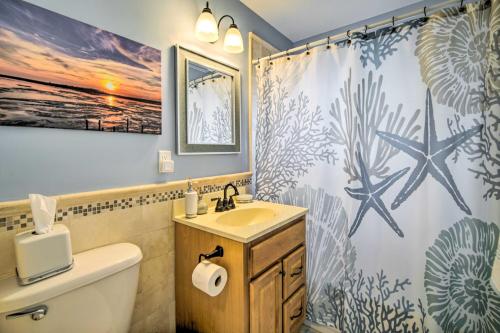 a bathroom with a sink and a shower curtain at Waterfront Beach Haven West Home with Boat Dock in Manahawkin