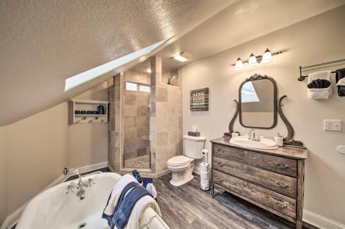 a bathroom with a tub and a sink and a toilet at Charming Kellogg Home Near Outdoor Activities in Kellogg