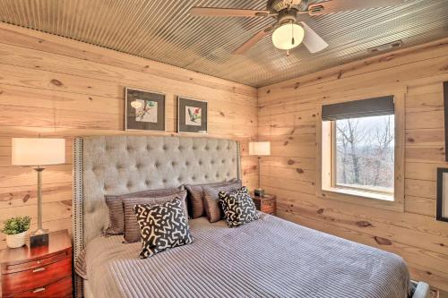 a bedroom with a bed with a ceiling fan at Mountain Home Cabin Rental with Fire Pit! in Mountain Home