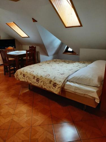 a bedroom with a bed and a table with chairs at Kazkowa Koliba in Zakopane