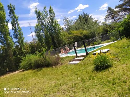a swimming pool in the middle of a field at Luna Azul in Nono