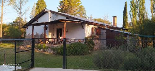 a small house with a fence in front of it at Luna Azul in Nono