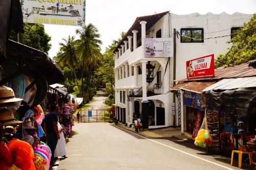 a street in a town with shops and buildings at Hotel Mi Paraíso Río Dulce in Castillo de San Felipe