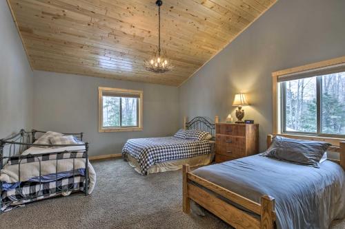 a bedroom with two beds and a wooden ceiling at Lakefront Cottage in Iron River with 2 Porches! in Iron River