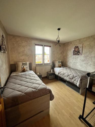 Postel nebo postele na pokoji v ubytování haut-Jur'Accueillant