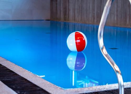 a pool with a red and white ball in the water at Hytte på Sørlandet - Søgne in Søgne