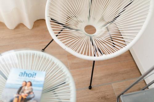 a table with two white fans and a sign on it at Penthouse NorderNice in Norderney