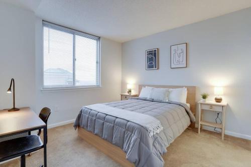 a bedroom with a bed and a desk and a window at Spectacular Condo 2/2 @Ballston With Gym in Arlington
