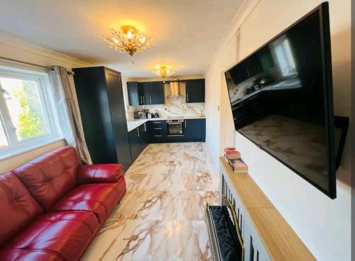 a living room with a couch and a large flat screen tv at Modern 2 bedroom flat by Dover Port, Castle& Sea! in Kent