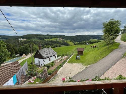 a view of a farm with a house and a field at Ferienwohnung Käppelehof in Schramberg