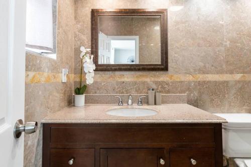 a bathroom with a sink and a mirror at Luxury Stylish Oceanfront 2 bedroom 2 bathroom in HOLLYWOOD FL in Hollywood