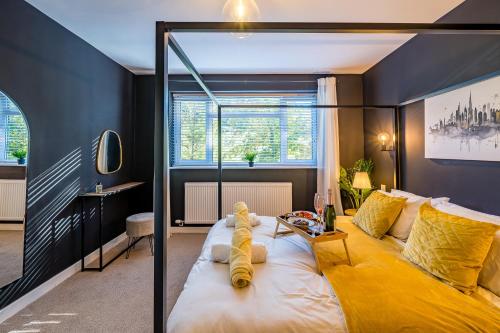 a bedroom with a large bed with a yellow blanket at Lake View Retreat, Pet Friendly, Free Parking, Lake View, Golf nearby in Bowness-on-Windermere