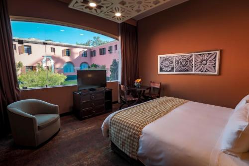 a hotel room with a bed and a large window at Wyndham Costa del Sol Arequipa in Arequipa