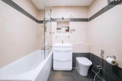 a bathroom with a toilet and a sink and a shower at The Sherborne Boutique in London