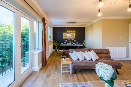 a living room with a couch and a table at Windermere Lake View Retreat, Pet Friendly, Free Parking, Golf nearby in Bowness-on-Windermere