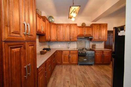 a kitchen with wooden cabinets and a stove at Aktea coastal village home in Kalymnos