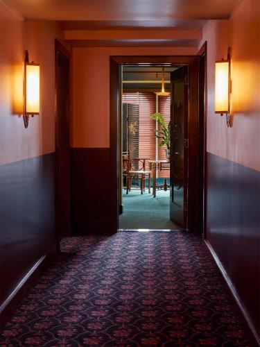 a hallway with an open door leading to a dining room at Hotel Ulysses, a Member of Design Hotels in Baltimore