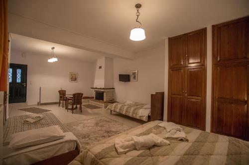 a bedroom with two beds and a dresser at Nefeles in Neochori