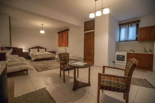 a kitchen and living room with a table and chairs at Nefeles in Neochori