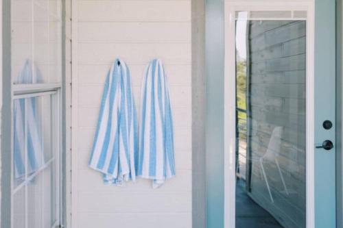 a pair of towels hanging on the side of a house at Unit 222 - The Lyndon 1 Bed - Cation on the Guadalupe in New Braunfels