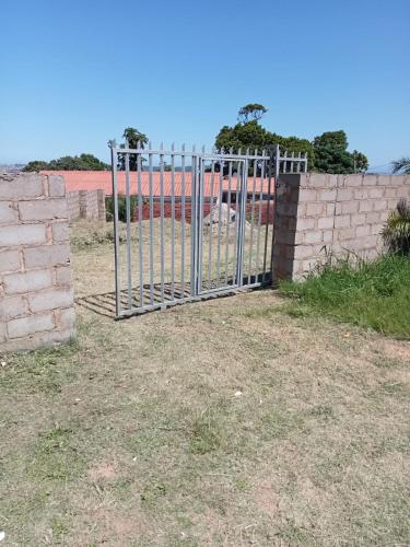 um portão em frente a uma parede de tijolos em Lamont Lodge em Durban