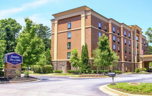 a building with a sign in front of it at Hampton Inn & Suites Flowery Branch in Flowery Branch