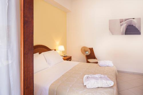 a bedroom with a bed with two towels on it at Hotel Orsa Maggiore in Vulcano