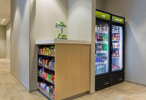 a grocery store aisle with two refrigerators and drinks at Home2 Suites By Hilton Charlotte Belmont, Nc in Belmont