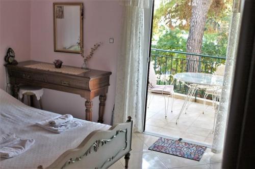 a bedroom with a bed and a piano and a balcony at Athens Riviera coast apartment in Athens