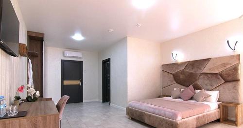 a bedroom with a bed and a desk in a room at Four Seasons In Carpathians in Migovo