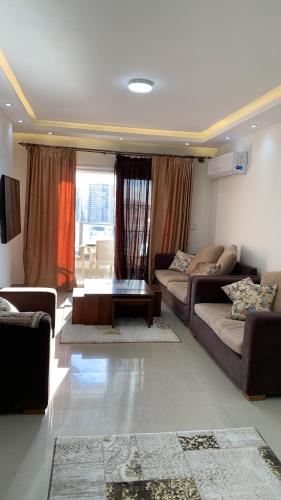 a living room with a couch and a table at شقة فندقية فاخرة luxury apartment sea view in Alexandria
