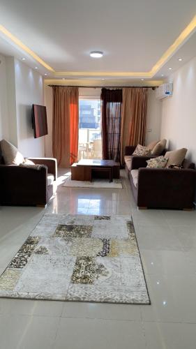 a living room with couches and a rug on the floor at شقة فندقية فاخرة luxury apartment sea view in Alexandria