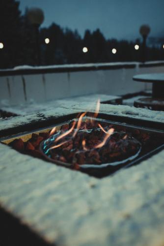 a pizza is cooking on a grill with flames at Smart Hotel Renzi in Folgarida