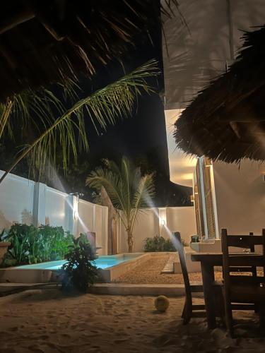a resort with a swimming pool at night at Lala salama Kendwa villas in Kendwa